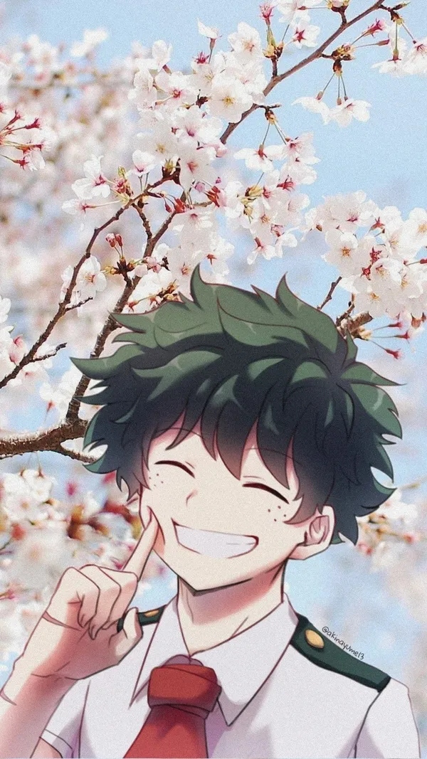 Anime boy with green hair and freckles is smiling in front of a cherry blossom