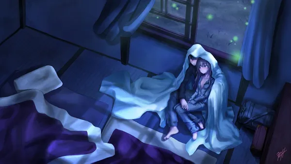 Couple is sitting on the floor in a room lit by a window