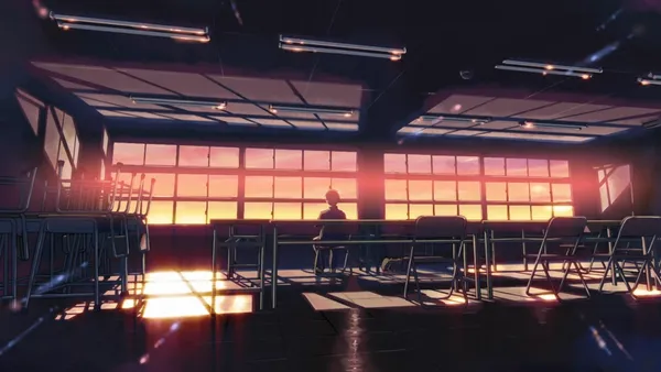 Empty classroom with a single student at sunset