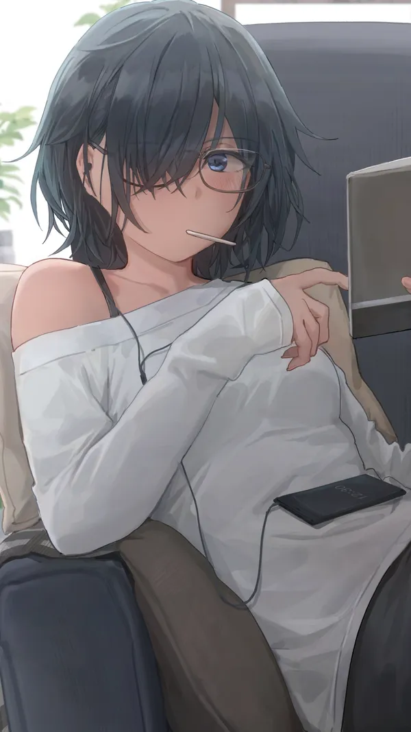 Girl wearing glasses is sitting in a chair and reading a book