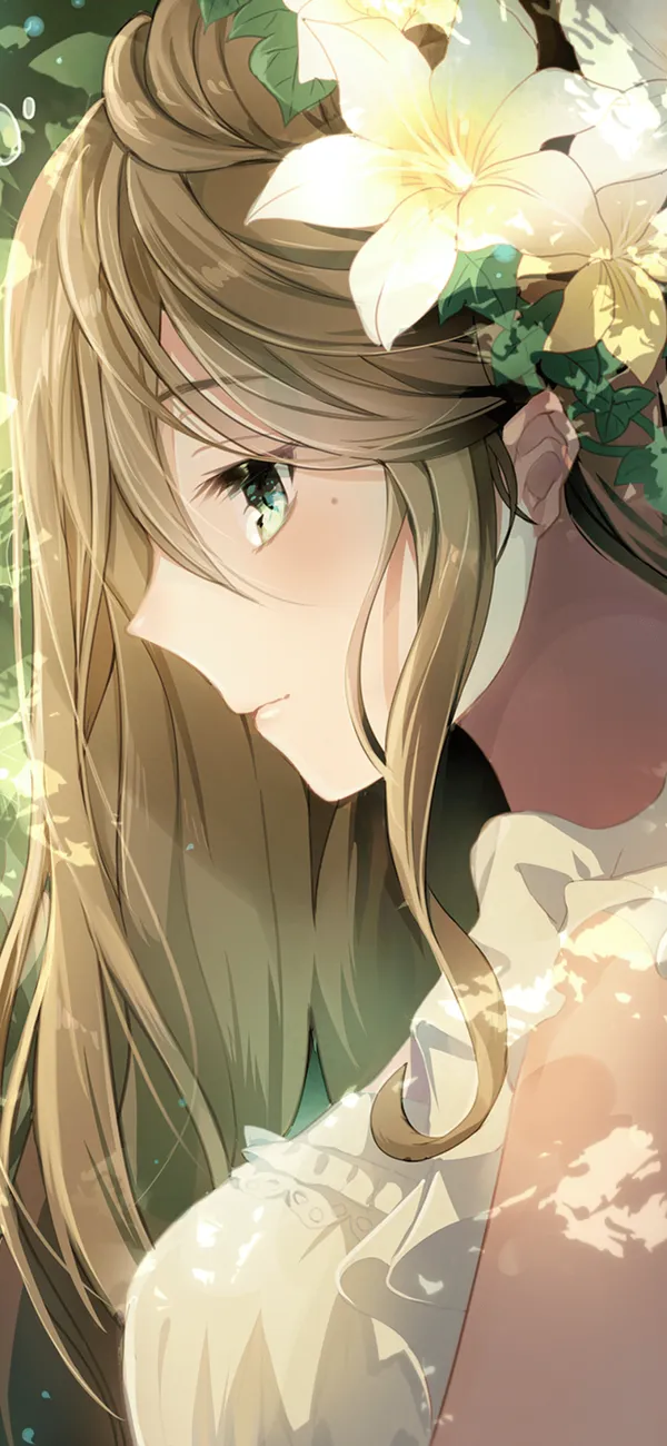 Girl with long brown hair and green eyes is looking down with a small smile