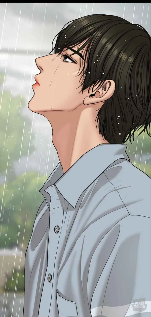 Man is standing in the rain with his head tilted back