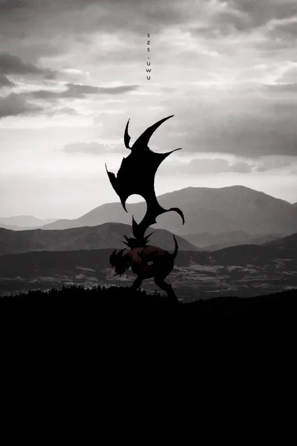 There is a creature with bat wings on top of a mountain